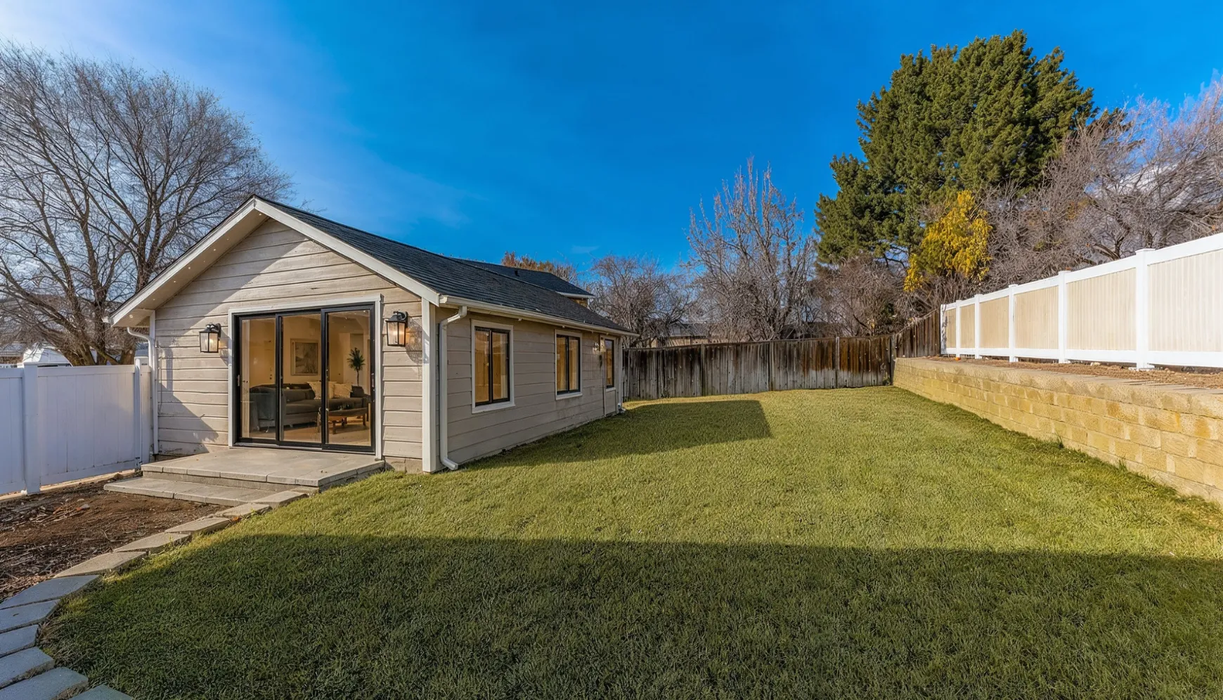 Detached ADU construction in Los Angeles CA featuring modern backyard unit with patio and glass doors