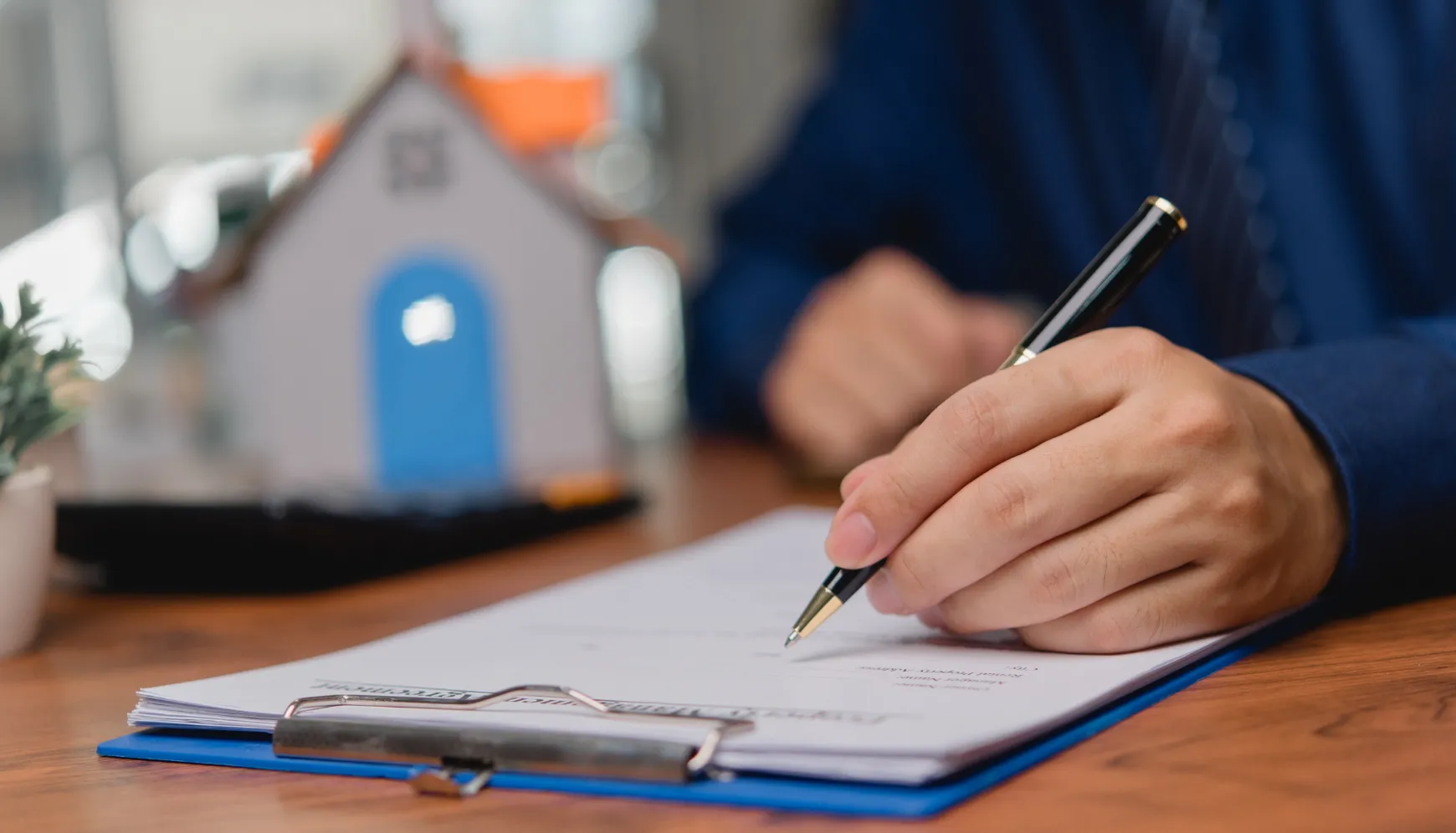 ADU permits and city approval in Los Angeles CA showing homeowner signing permit documents for construction approval