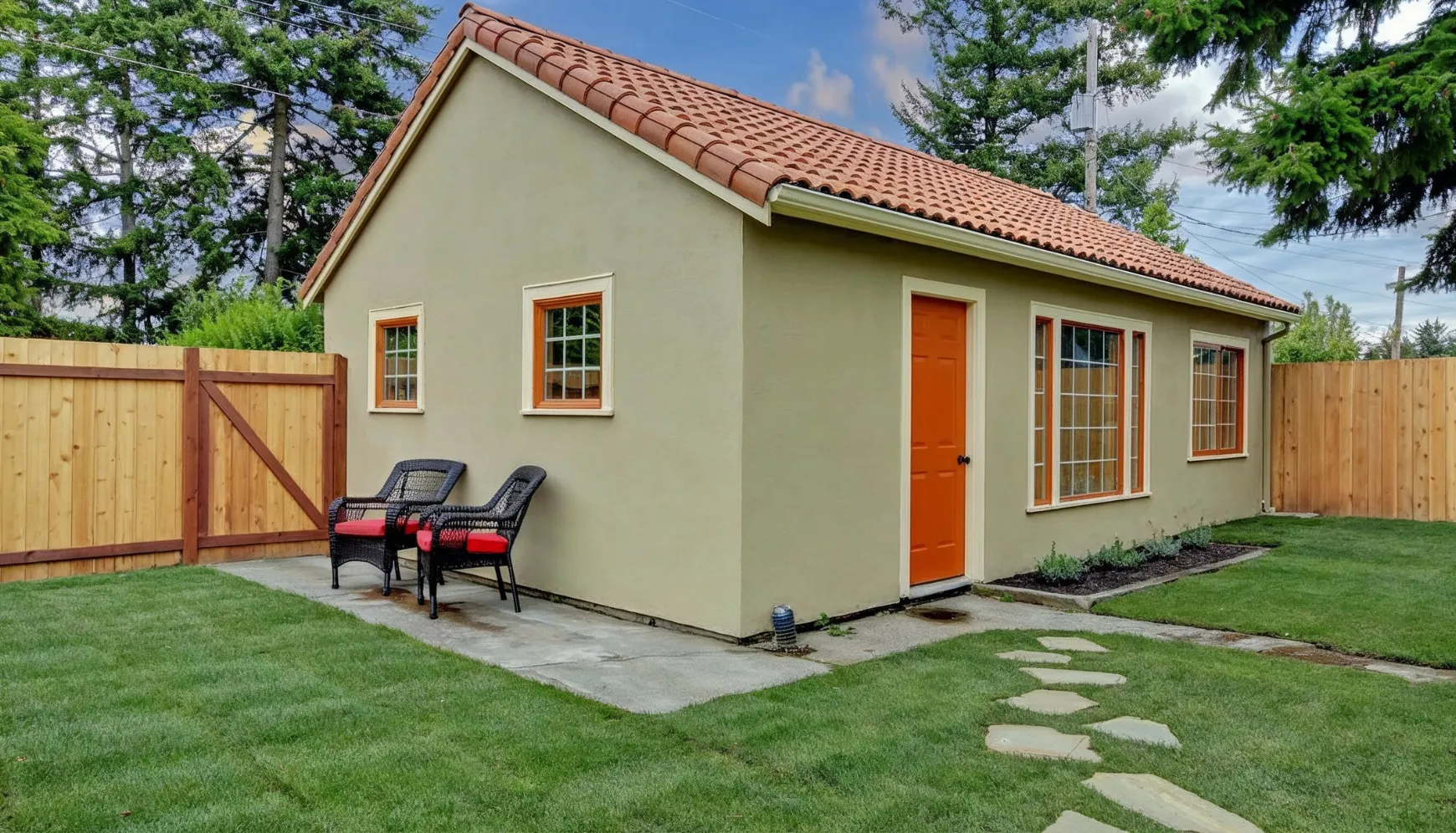 Detached ADU construction in Los Angeles CA featuring completed stucco backyard unit with private patio and entrance