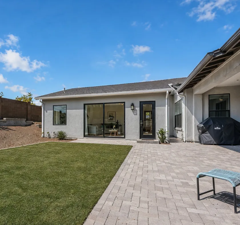 Attached ADU construction in Los Angeles CA showing stucco home addition with backyard patio and seamless integration